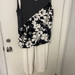 Josephine Chaus Plus size white pants and black and white floral shirt.